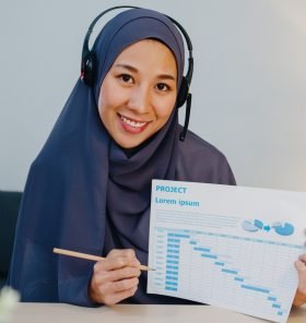 muslim-lady-using-laptop-talk-to-colleagues-in-vid-9YBZ8E8